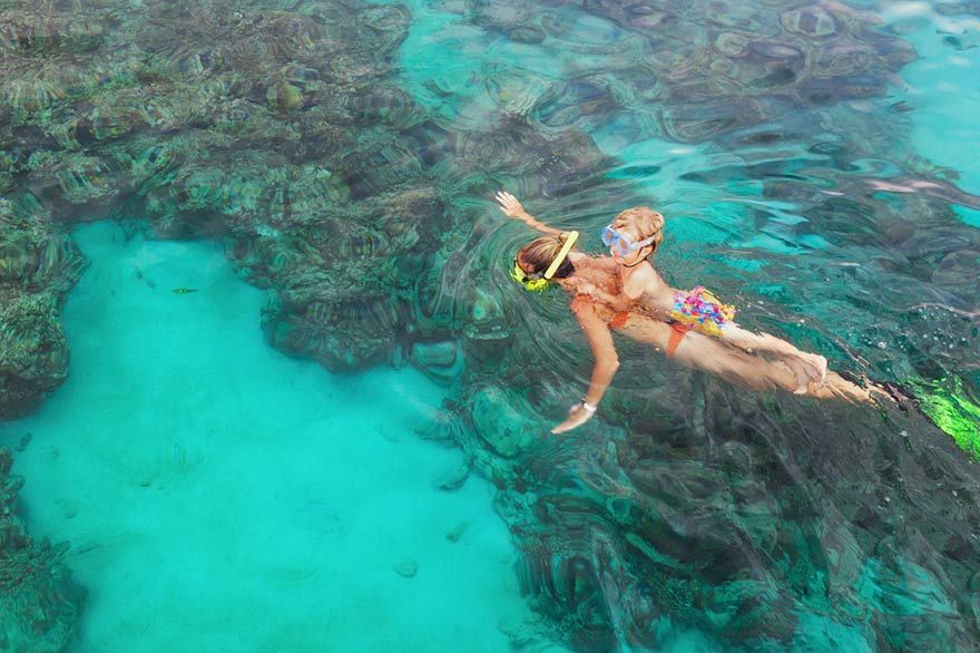 Women diving with her son in the Caribbean Sea in the Dominican Republic