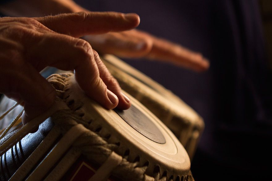 Hände einer Person, die Bongos spielt